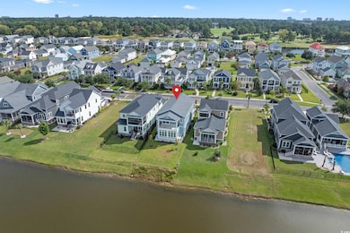 Aerial perspective of suburban area with a large body of water and a tree filled landscape