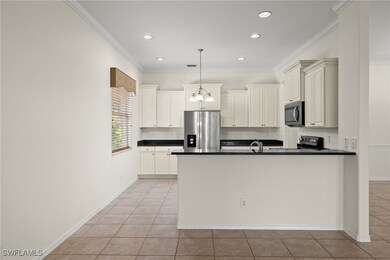 Kitchen featuring ornamental molding, stainless st