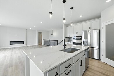 Prepare your meals in style.  Lots of counter space, large eat in quartz countertop island.  (Picture of actual home.)