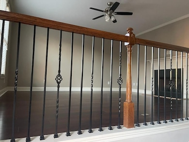 Detailed view of ceiling fan, crown molding, and a gate