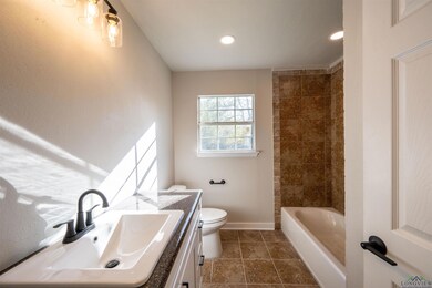 Full bathroom featuring tile patterned flooring, v