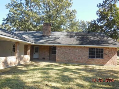 Back of property featuring a yard