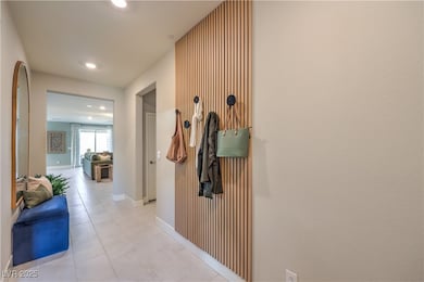 Hallway featuring recessed lighting, light tile pa