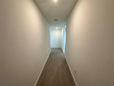 Hall with dark wood finished floors and baseboards