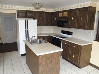 Kitchen with island and tiled floor...