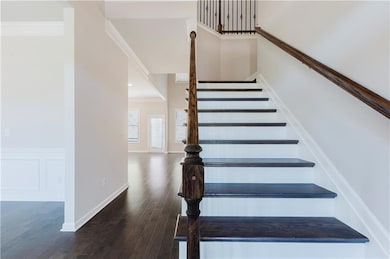 Stairway featuring crown molding, wood finished fl