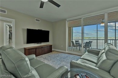 Living room with ceiling fan and wood-type floorin