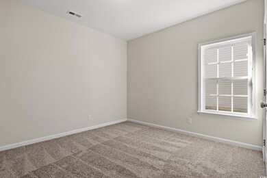 Empty room featuring carpet flooring