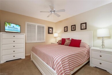 Carpeted bedroom with a ceiling fan
