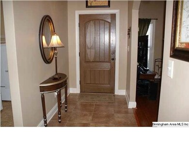 Foyer has tile floor and opens to the family room.