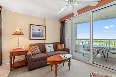 Tiled living room featuring ceiling fan and orname