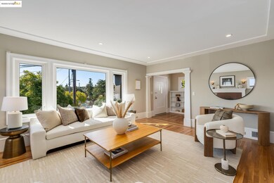 Living room featuring light wood finished floors, recessed lighting, and decorative columns