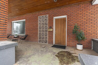 View of exterior entry featuring brick siding