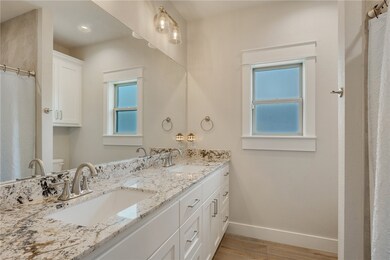 Bathroom with a sink, toilet, baseboards, and wood