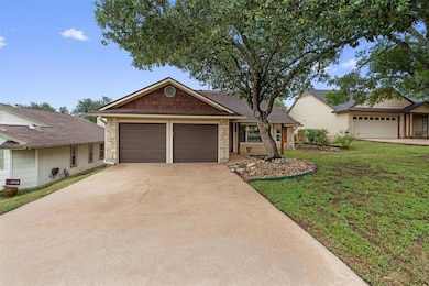 Ranch-style home featuring stone siding, a front 