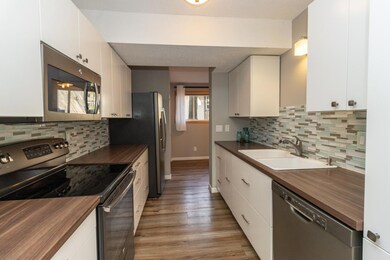 Spacious updated kitchen-circa 2015 with GE stainless steel appliances, all new counters, new white cabinets, soft close doors and drawers. Loads of cabinets, plus a side pantry front right.