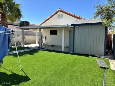 Rear view of house featuring a patio area, a fence