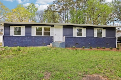 Single story home featuring brick siding, a front 