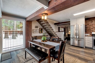 Sunny dining area with huge windows and slider to back deck.