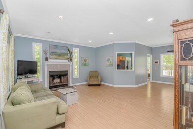 Living area featuring a tile fireplace, baseboards