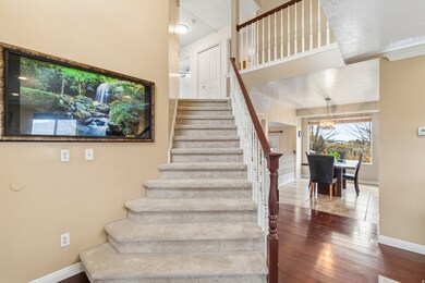 Stairway featuring hardwood / wood-style floors and a chandelier