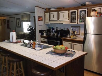Spacious kitchen with large working island.  Seller has purchased another home and will be taking these appliances and replacing them with white ones.