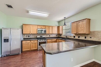 Kitchen featuring stainless steel appliances, dar