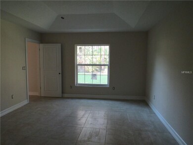 Master Bedroom with tile floors and tray ceiling