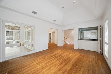 The living room flows seamlessly into the rest of the home. Featuring a fireplace, built-ins, high ceilings, hardwoods, and entrance to the atrium.