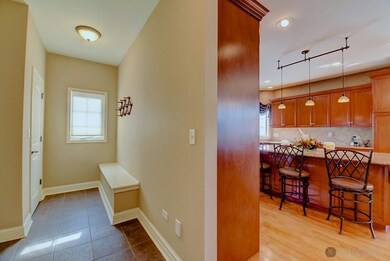 Spacious mudroom with a bench and dual closets.