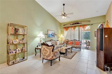 Living room featuring a ceiling fan, lofted ceilin