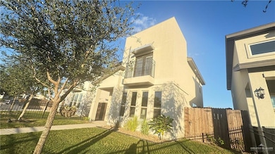 View of side of property with a balcony and stucco siding