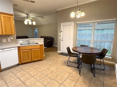 Kitchen with white dishwasher, ornamental molding,