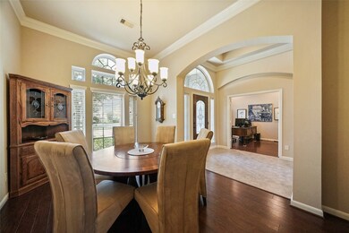 Lovely formal dining area features large, elegant chandelier, picture window & high ceilings.