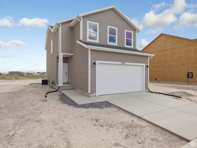 View of front of house featuring a garage and driveway
