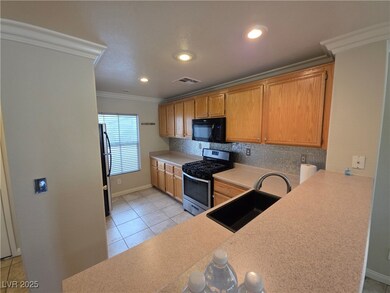 Kitchen with stainless steel appliances, a sink, t