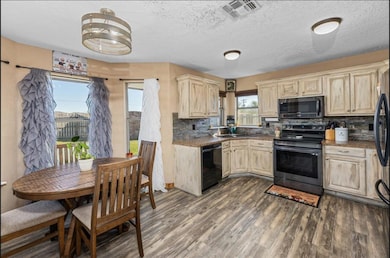 Kitchen featuring sink, stainless steel range with