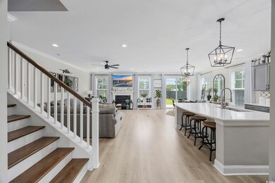 Kitchen with light wood-type flooring, hanging lig