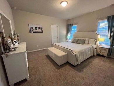 Bedroom featuring carpet floors and baseboards