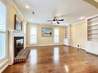 Living room with brick fireplace, built ins and pl
