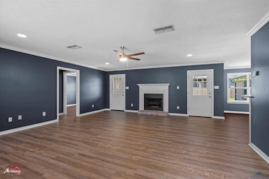 Unfurnished living room with baseboards, visible v