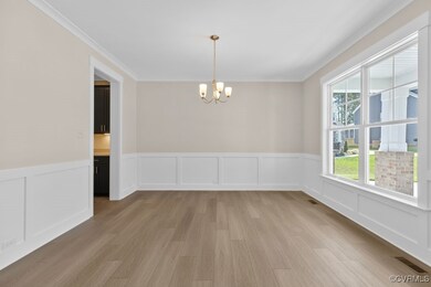 The formal dining room features a chandelier and i