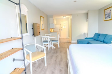 Bedroom featuring light wood-style floors and crown molding