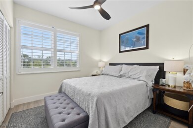 Bedroom with ceiling fan, a closet, and hardwood /
