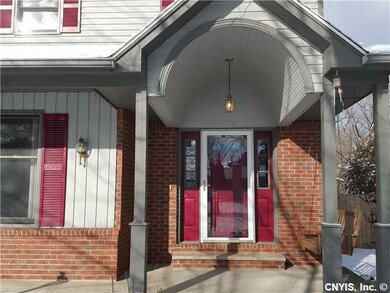 Exterior Front. Detailed entryway with storm door