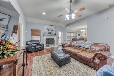 Wood burning fire place in the living room with ample space for a sectional & lounge chairs