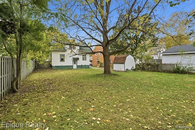 Fenced backyard with a storage unit