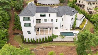 Rear view of property with stucco siding, roof mou