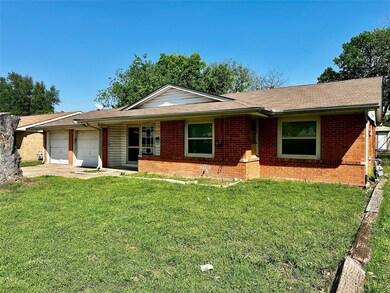 Ranch-style house with brick siding, a front yard,