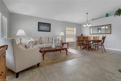 Living room with an inviting chandelier and vaulte